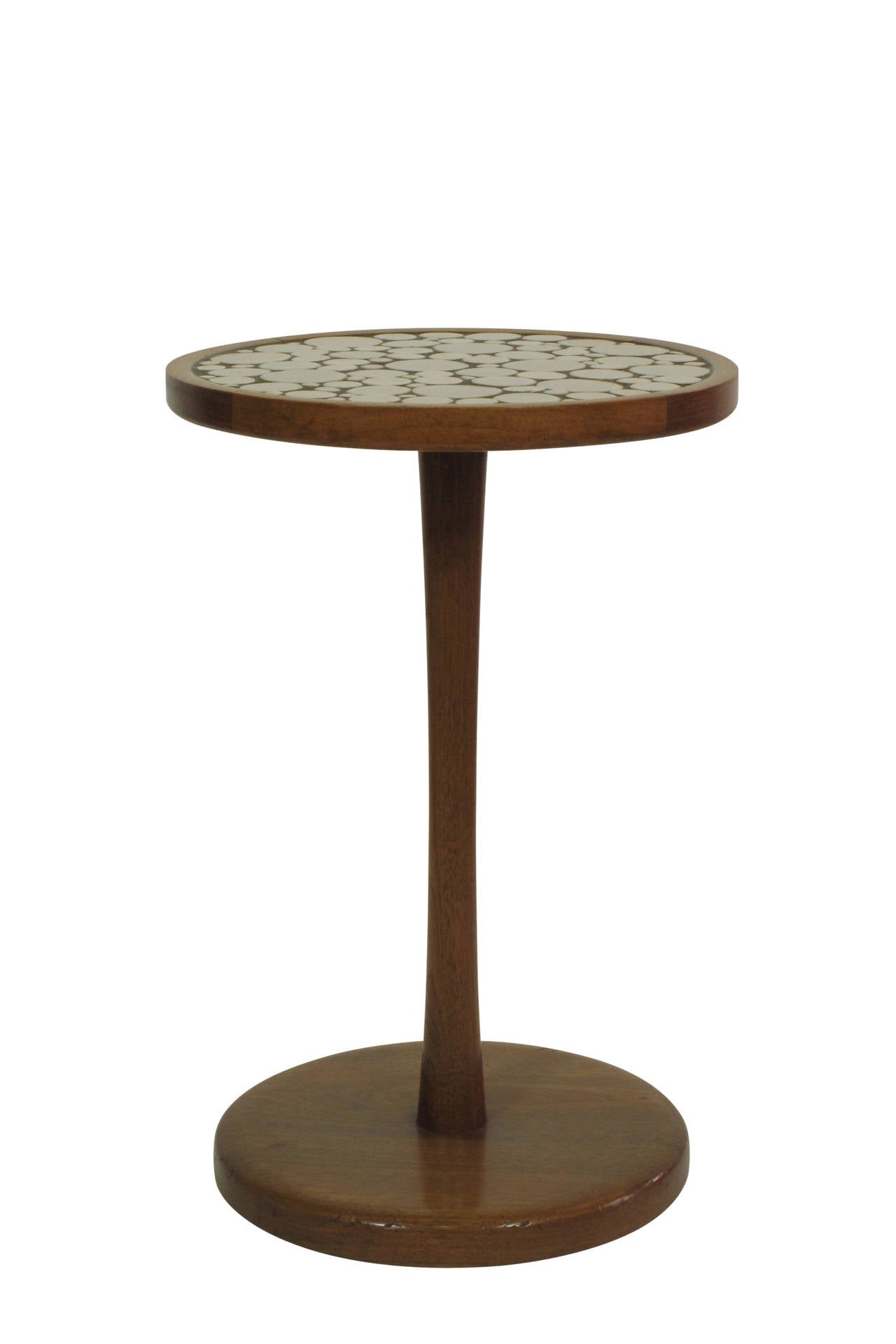 Iconic table with 11.5 inch diameter top. Walnut frame with weighted base.
