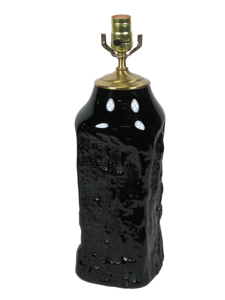 Sculptural mold blown black glass with organic relief design and brass hardware. Wired from the socket. Querandi of Argentina. Retains manufacturer's paper label.