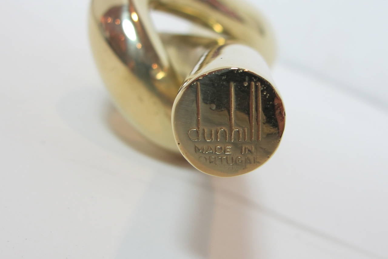 Great design object. Dunhill paperweight in brass. Made in Portugal. Marked on one end of the 1/2