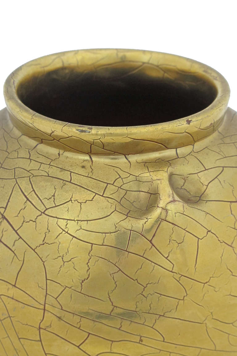 Gold over red glazed classic urn form with pinched impressions.
