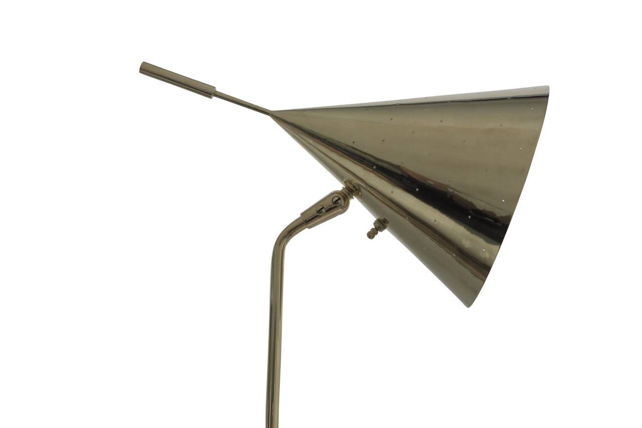 Chic brass reading lamp with an adjustable perforated cone. Purchased from the estate of Nathan and Janet Appleman of Ocean, New Jersey. The Applemans commissioned Tommi Parzinger to design the interior.