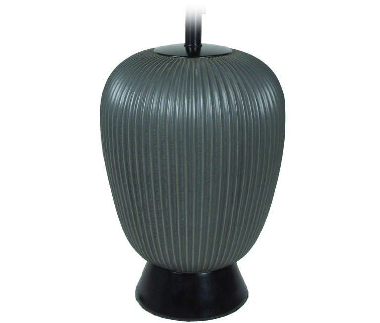 Fine fluted porcelain lamp in gunmetal by Gerald Thurston for Lightolier. Three-way socket with new wiring for immediate use.