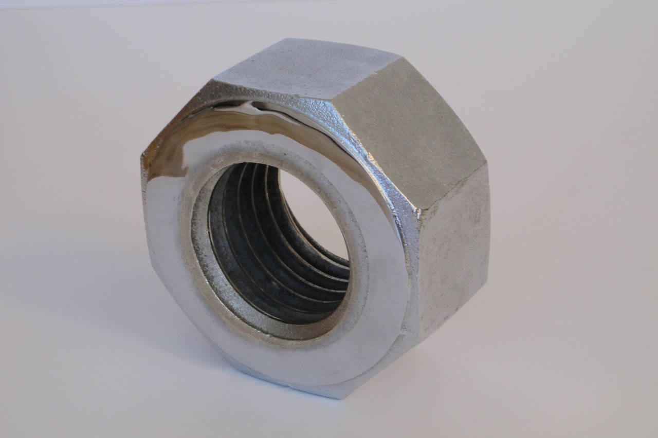 Great object. Two textures of finish to the metal. Polished nickel front and back contrasted with a smooth pebbled texture to the sides of the octagon. Real threads. Weighs 16 lbs.