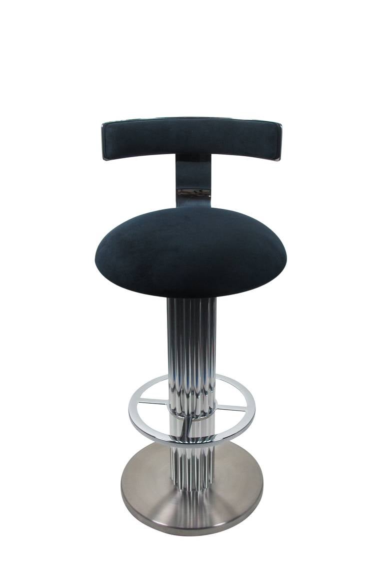 Pair of bar stools in nickel plated steel and aluminum by Designs For Leisure, a high quality seating resource for the Interior Design Trade in the 1970s and '80s.
Upholstered in rich navy ultra suede with polished steel backrests, polished steel