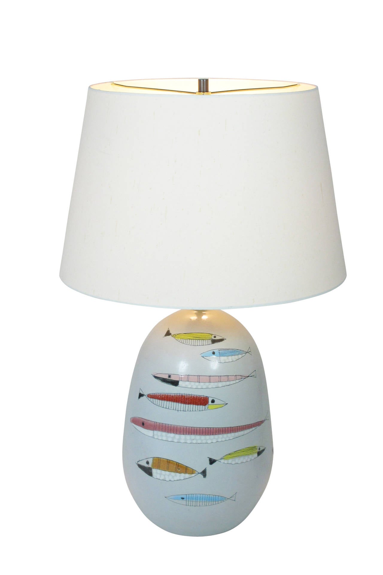 Colorfully decorated lamp with modernist fish over a pale grey glaze. Rewired with new bronzed double cluster for immediate use. Marked: B 46. Italy on bottom of ceramic. Ceramic only measures: 14.5 inches.