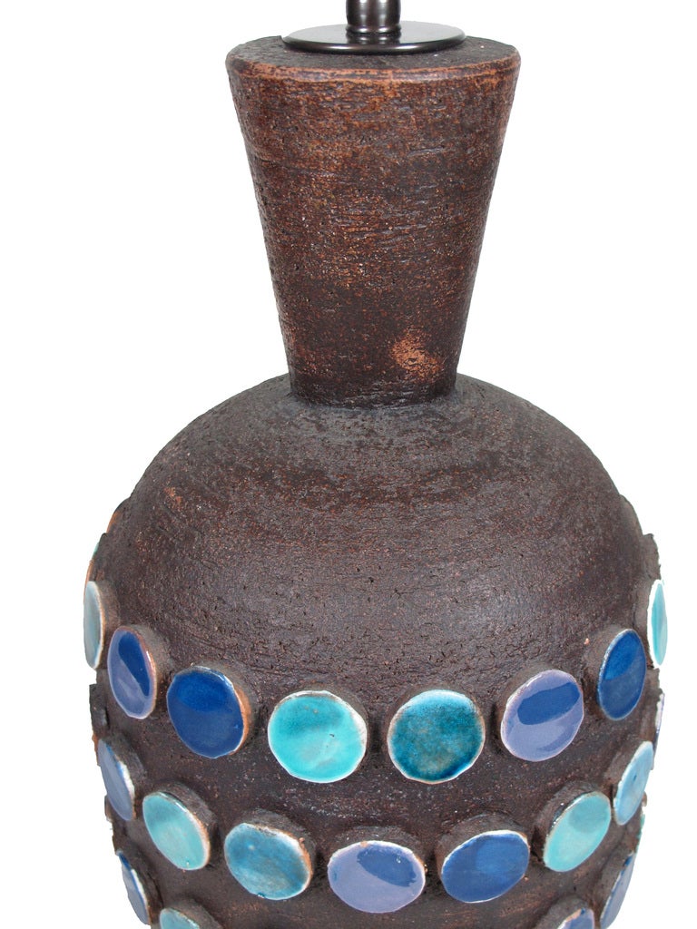 Bitossi  Aldo Londi Ceramic Table Lamp Applied Discs Signed Italy 1960's. Dark chocolate brown glazed pottery lamp with blue/purple and aqua glazed appliqué discs. Measures: 30" to top of finial. Ceramic 17.5". Signed Italy on base of