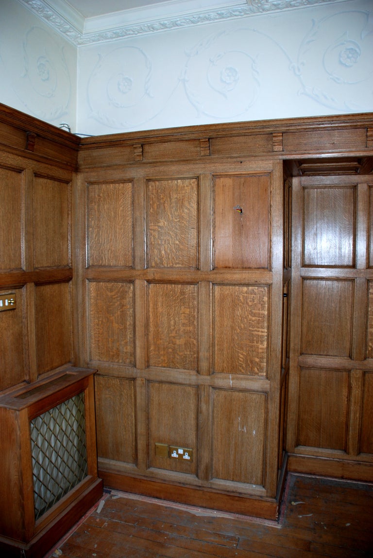 An oak panelled room with stone fireplace For Sale 1