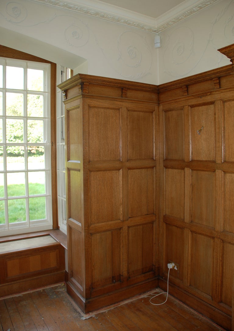 Oak An oak panelled room with stone fireplace For Sale