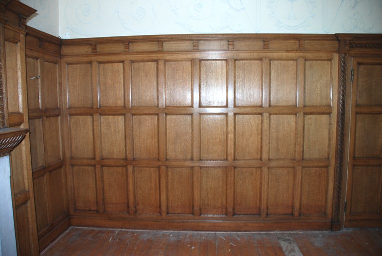 An oak panelled room with stone fireplace, circa 1910, removed from 'Queen Anne House', Oxshott, Surrey, England, the former residence of the well know golfer Colin Montgomery..

This well constructed room, made from English Oak, comprises of a