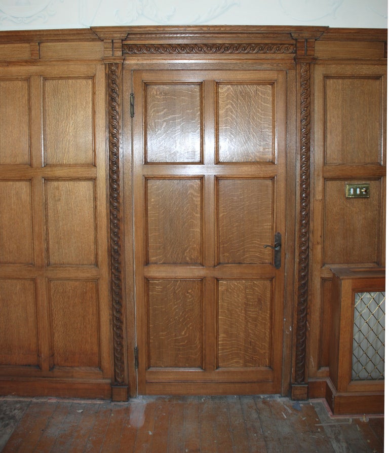 British An oak panelled room with stone fireplace For Sale