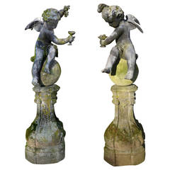 A pair of early 20th century winged lead putti