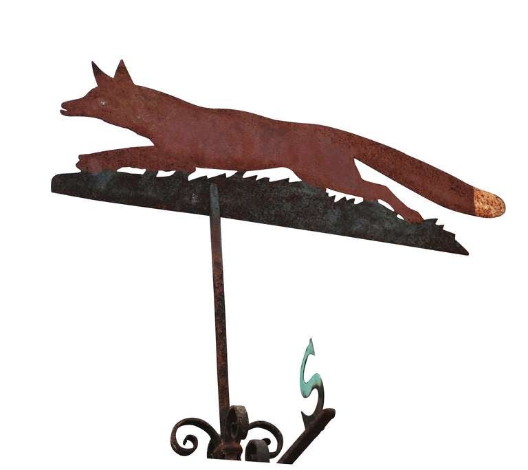 An early 20th century, circa 1900, wrought iron weather vane,  the indicator being a painted cut sheet iron fox with copper compass points.