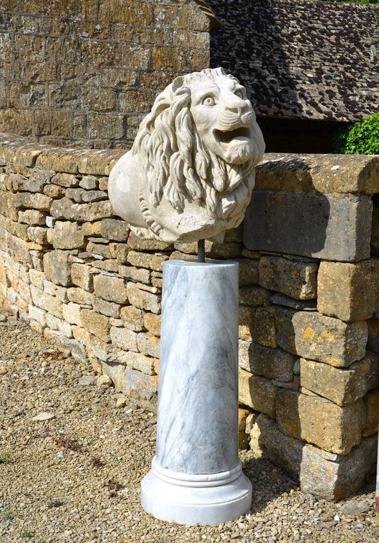 A 19th century, circa 1840, Portland stone lion fragment. 

 Reputedly from Chatham Docks, raised upon a marble column.