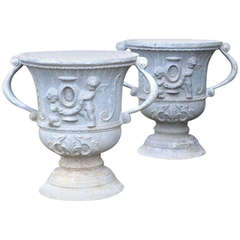 A pair of early 20th century lead urns of campana form