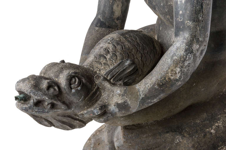 English An early 20th century lead fountain in the form of a boy holding a fish