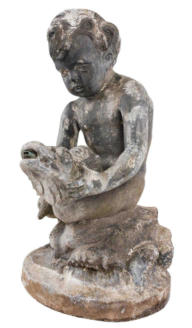 20th Century An early 20th century lead fountain in the form of a boy holding a fish