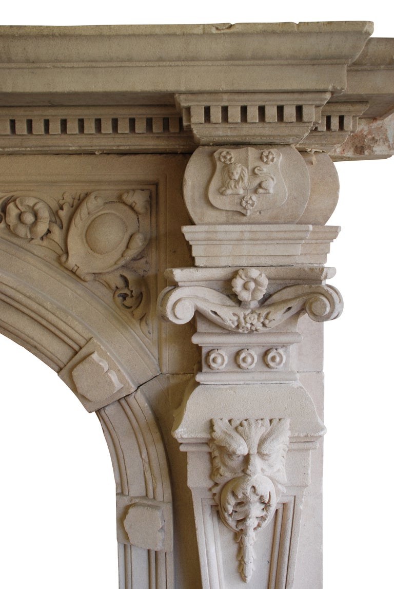 An impressive early 19th Century fireplace in natural limestone. The arched aperture having ornately carved central corbel flanked by elaborate spondrels. The jambs in the form of flat pilasters recessed and carved with roses and foliage capitols.