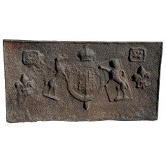 A cast iron fireback depicting lions rampant