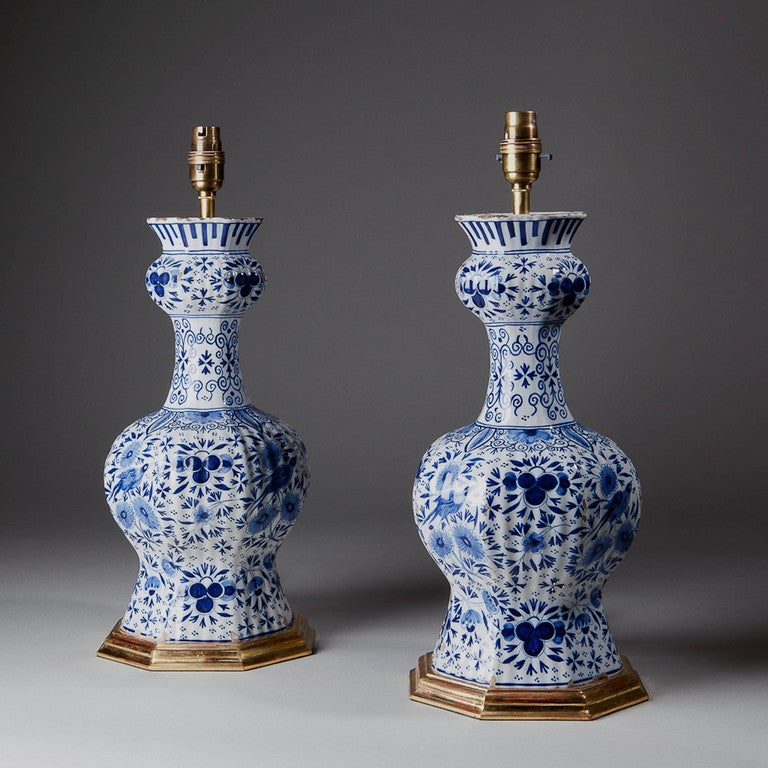 A pair of octagonal delft bulbous vases in blue and white, decorated in the traditional pattern with birds among foliage and flowers. Each signed on the base with the mark for Johannes van Duijn 1764 - 72. 

Height of vase 14 inches 
Height to