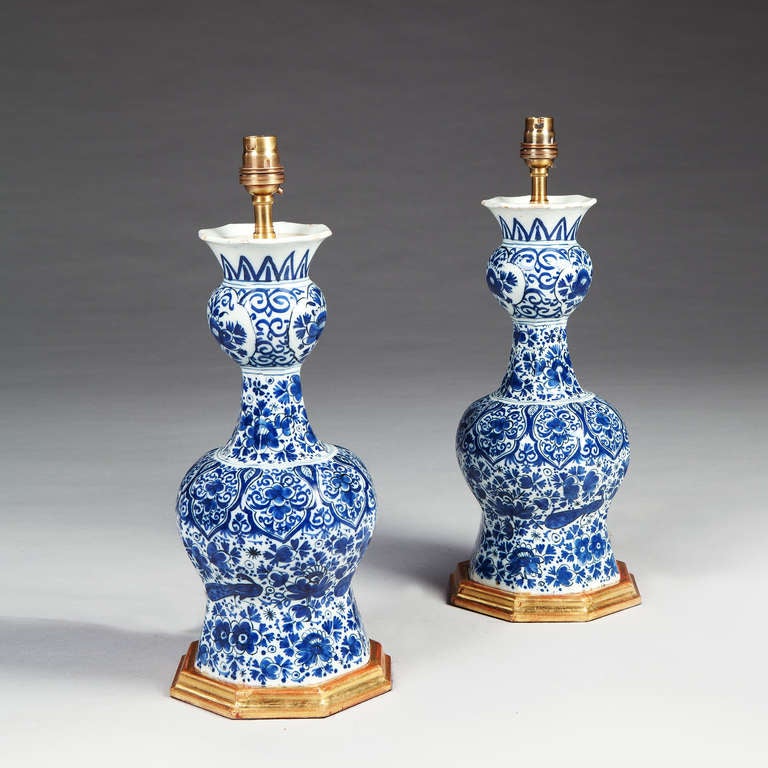 A fine pair of 18th century delft knobble vases decorated with peacocks and flowers in blue and white, now mounted as lamps.

Height to light fitting 42cm / 16.5in