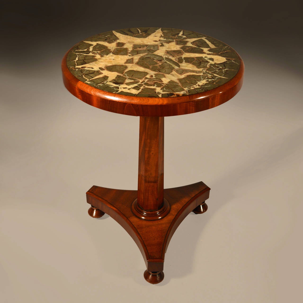 A fine mid 19th century mahogany occasional table, the top inset with a large fragment of turtle stone with turned pedestal and tripod base.