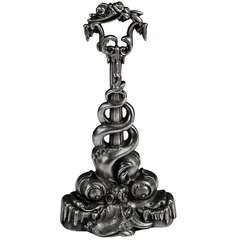 A Polished Cast Iron Chippendale Door Stop