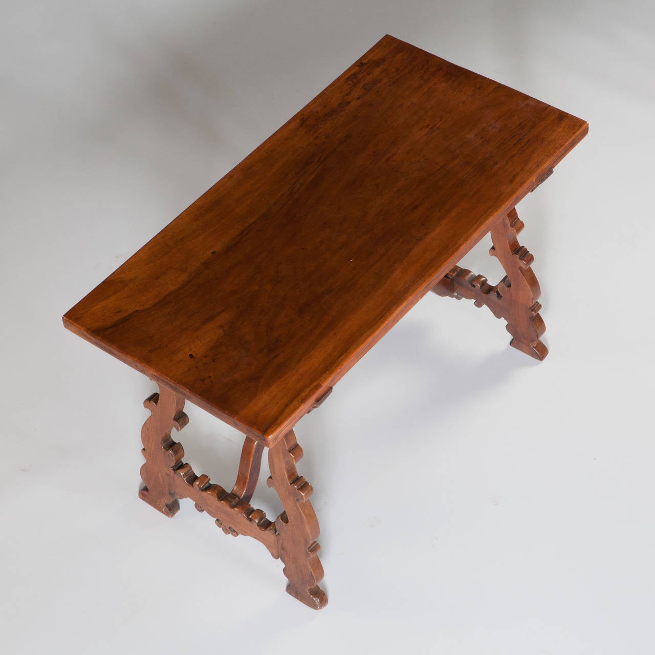 A spanish centre table with shaped legs and stretcher.