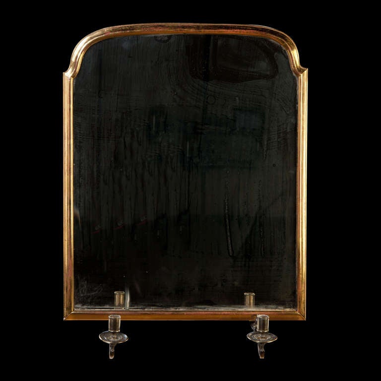 A fine early 18th century gilt wood mirror pier mirror with brass candle sconces.