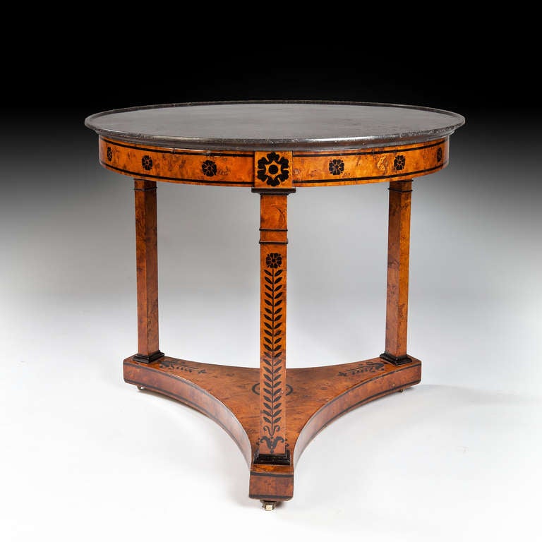 A very fine Charles X period gueridon centre table veneered throughout in burr elm, with lacquered ornament. Retaining its original black Belgian marble.