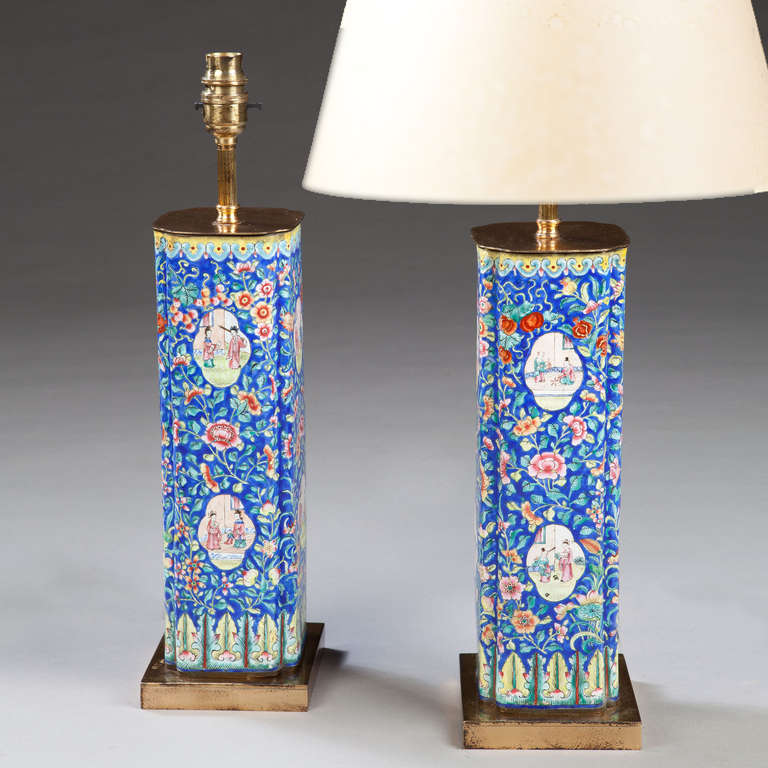 A fine pair of rich blue Canton enamel vases decorated with scenes of domestic life now mounted as lamps with gilt metal bases.