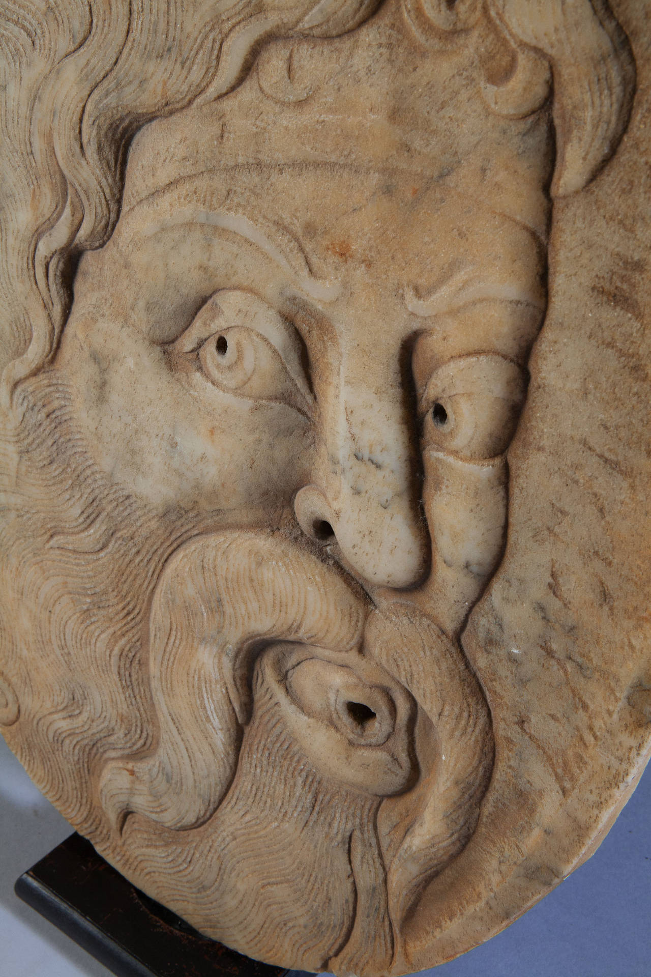 A rare late seventeenth century carrera white marble sculpture of a bearded Turk, dramatically carved in low relief, originally mounted on a wall as a fountain head.