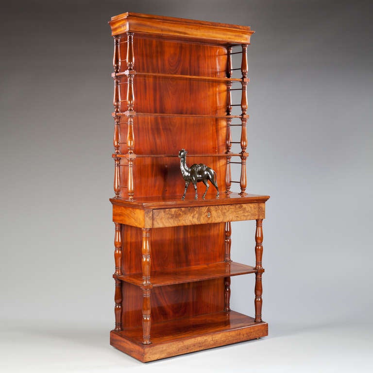 A set of French Empire mahogany etagere shelves each shelf supported on Jacob turned supports.