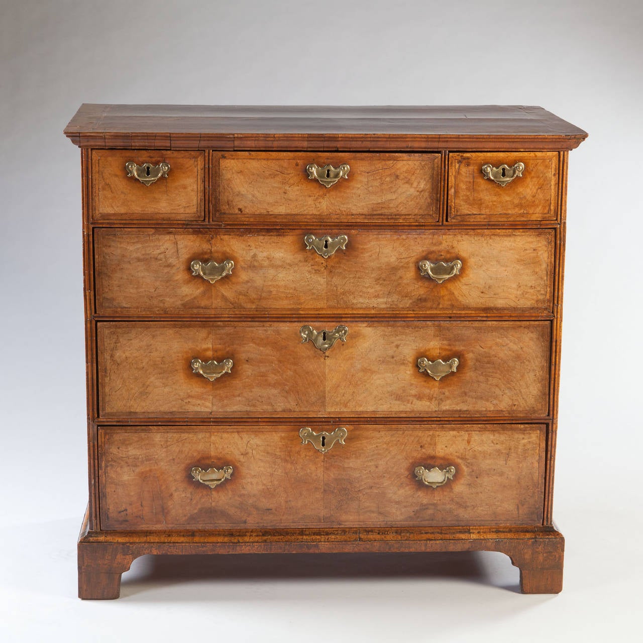A fine early eighteenth century walnut chest of drawers of good colour with graduated drawers, brass handles, all supported on bracket feet.