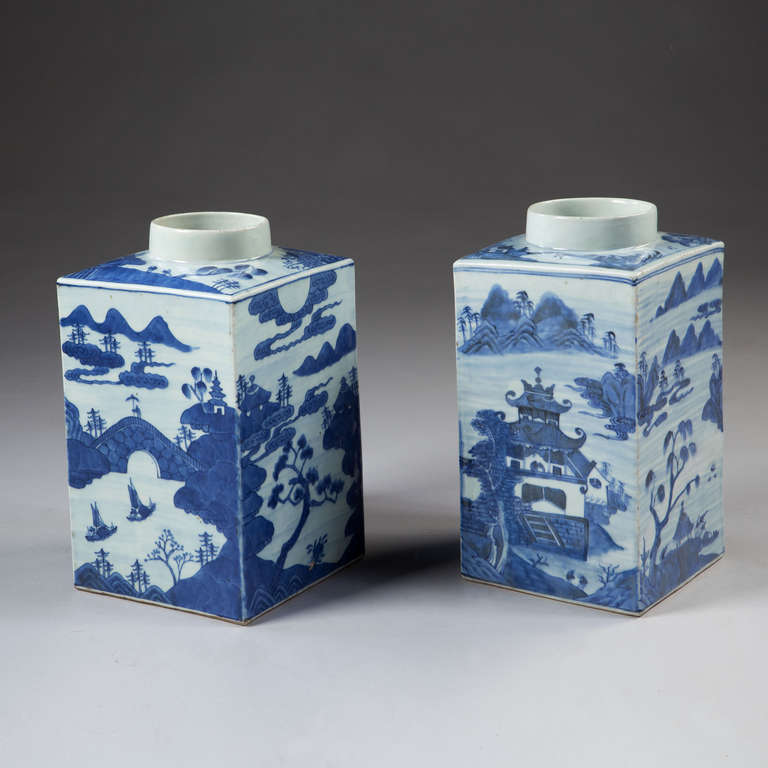 A fine pair of early 19th century blue and white square tea jars, decorated with landscapes and mountainous scenes.