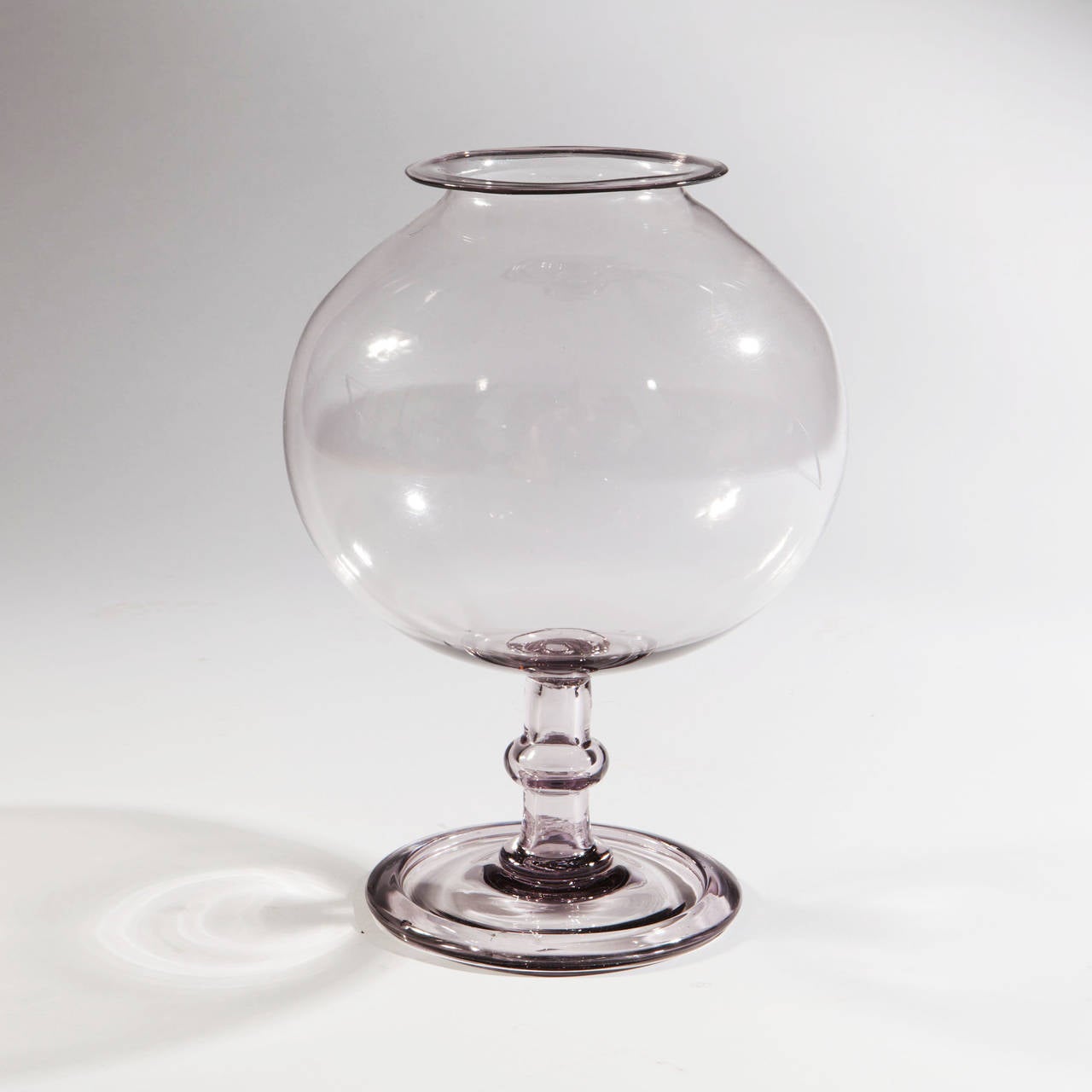A rare mid-18th century glass fish bowl of large scale supported on a wide circular foot