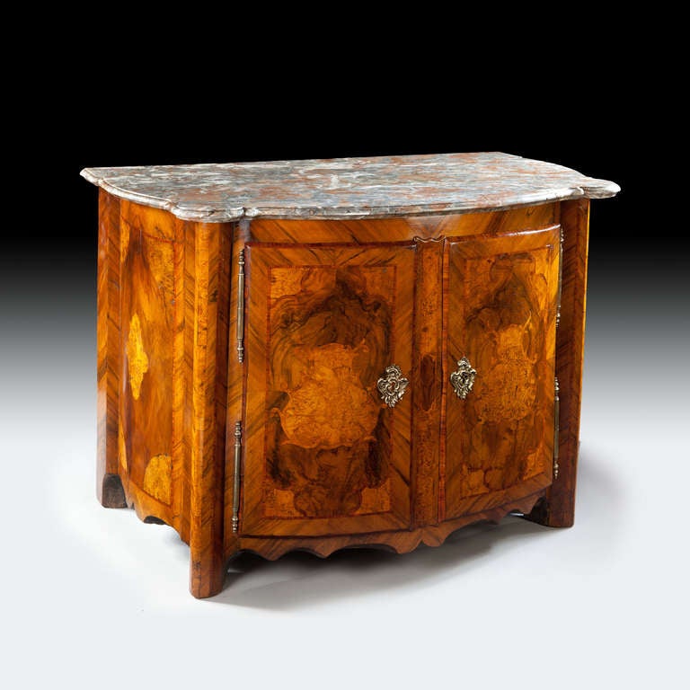 A fine early 18th century Rhenish cabinet or credenza of substantial proportions, the marquetry front and sides in richly figured burr veneers of elm, yew, and walnut set within reserves of figured walnut, the whole constructed of oak. The bombe