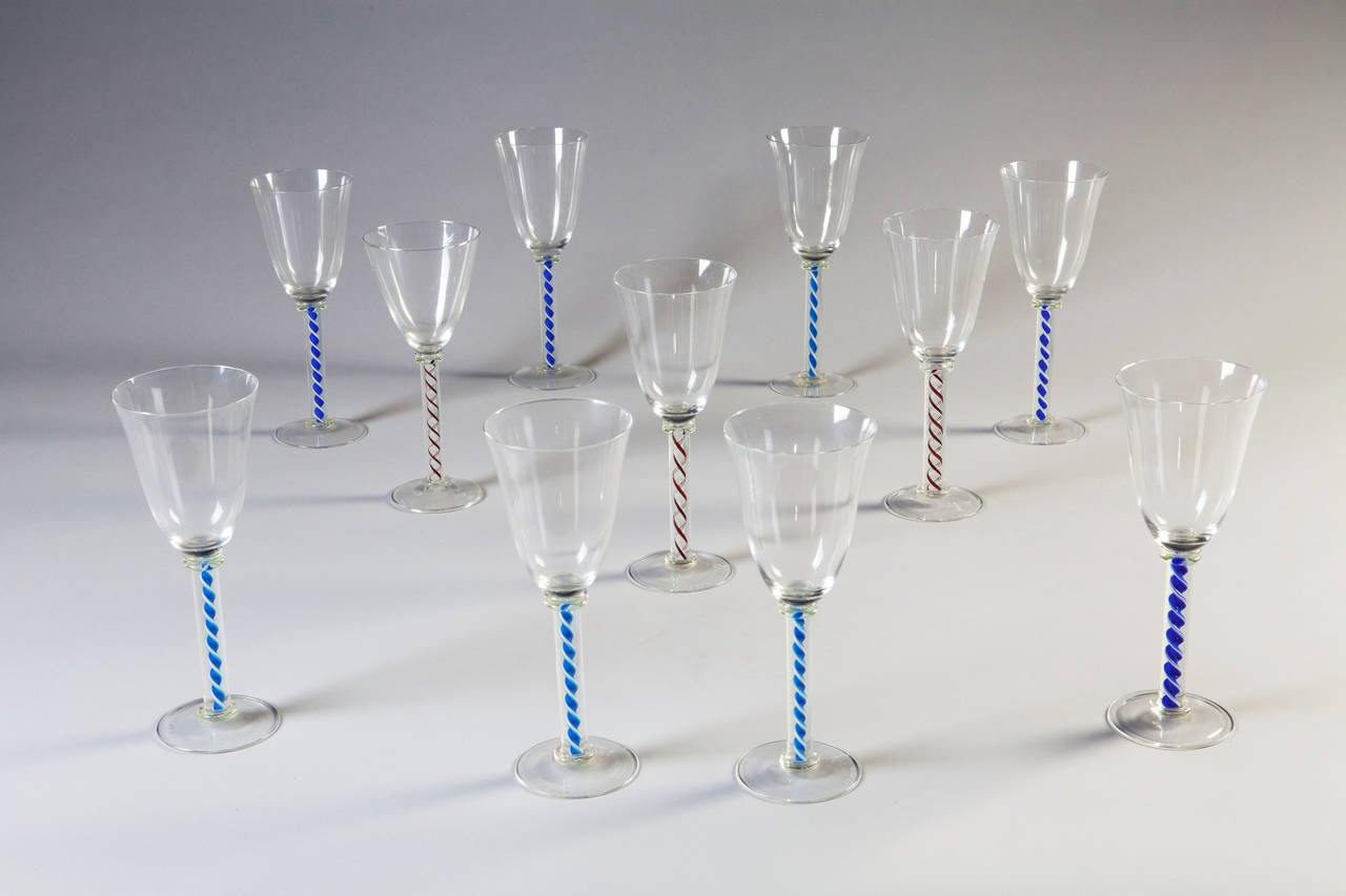 A fine set of twelve spiral twist wine glasses of different colours, all signed Edward Hill 

Edward Hill is an English glass maker who trained at the world famous glass works in Murano, Venice. He made drinking glasses for a number of years and