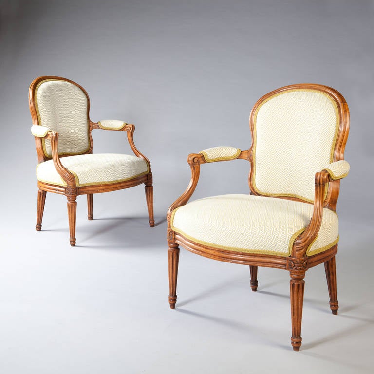 A fine pair of mid 18th century transitional fauteuils armchairs, the kidney shaped backs running to curvaceous arms raised on classical fluted and tapering legs. Stamped N.S.Courtois (Nicolas Simon Courtois maitre 1766 - Paris) 

The term