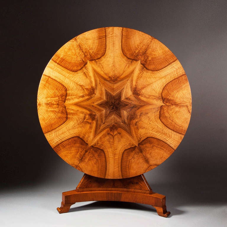 A fine early nineteenth century walnut and olivewood centre table, with top of radiating veneers of superb colour.