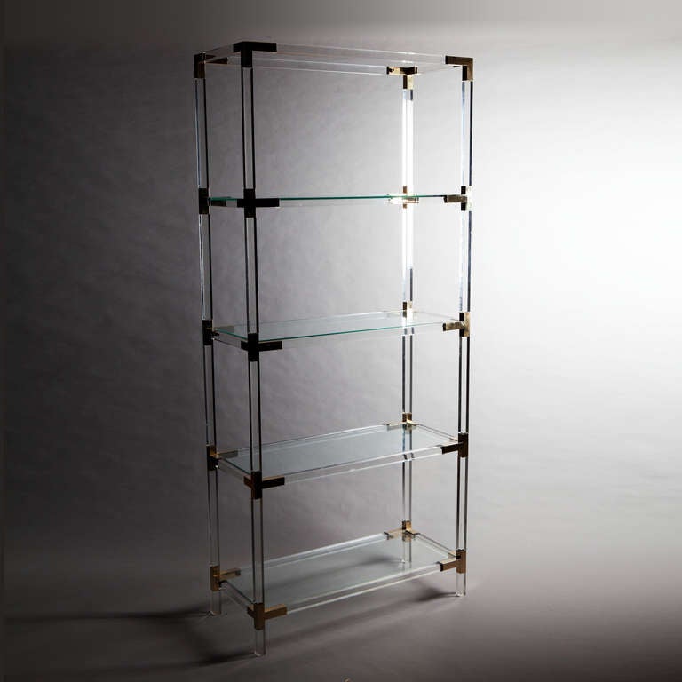 A set mid twentieth century perspex shelves mounted with brass
corners.