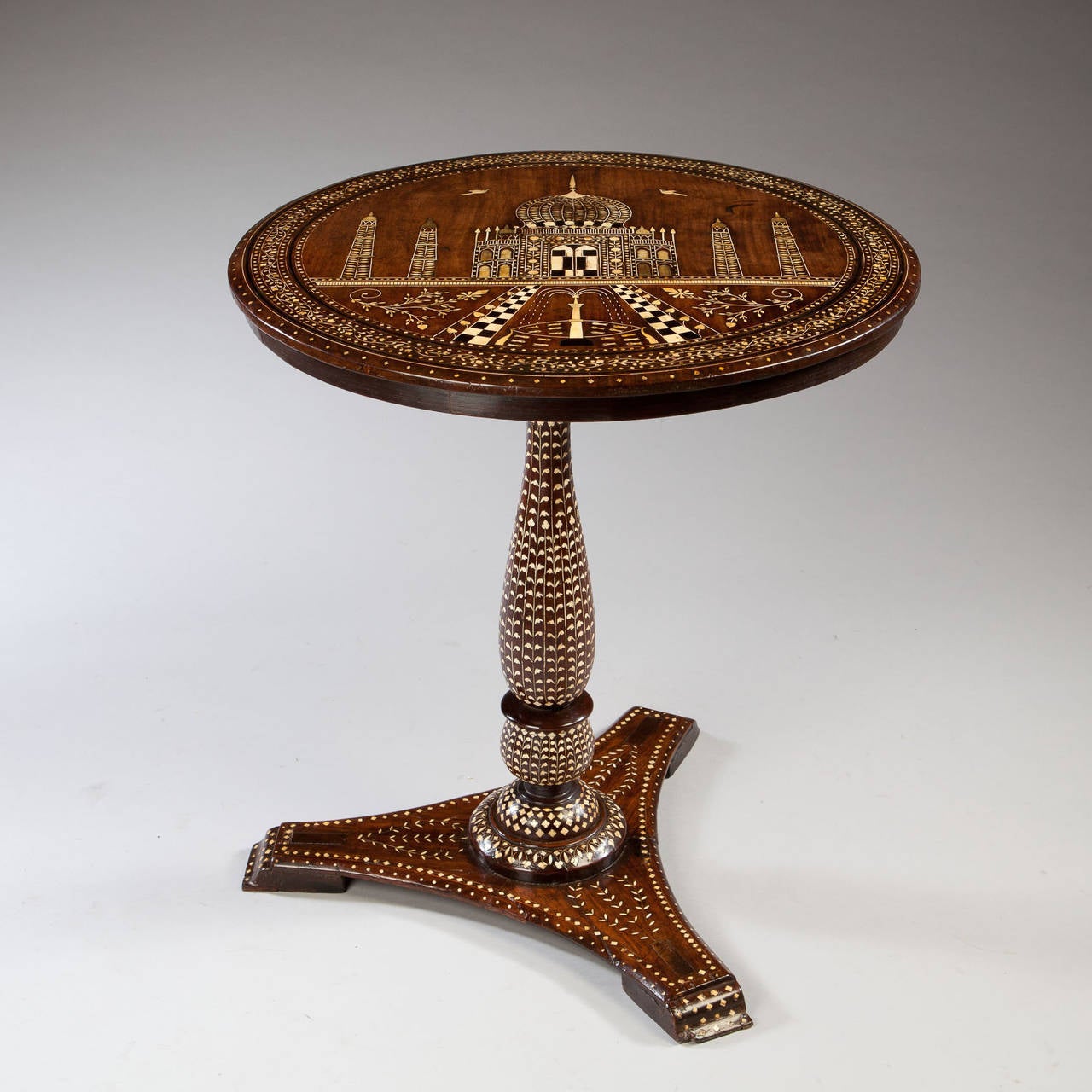 An exceptional early 19th century padouk occasional table inlaid with bone throughout, the top decorated with the Taj Mahal which was built by the Emperor Shah Jahan in memory of his beloved wife Mumtaz Mahal.