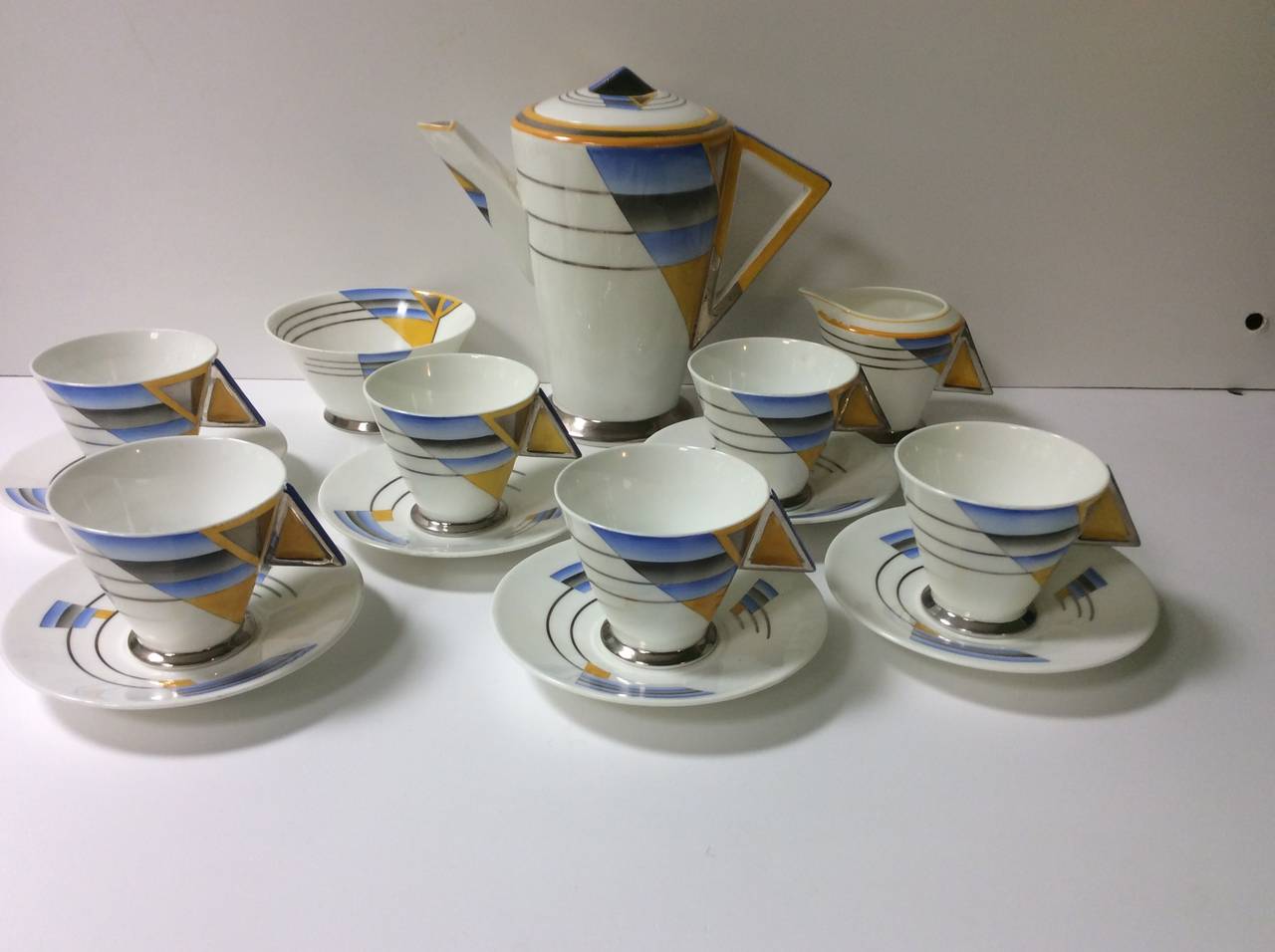 A Rare Shelley Coffee Service for six on the Art Deco Mode Shape designed by Eric Slater, with the Stunning Shades and Lines pattern # 11760.