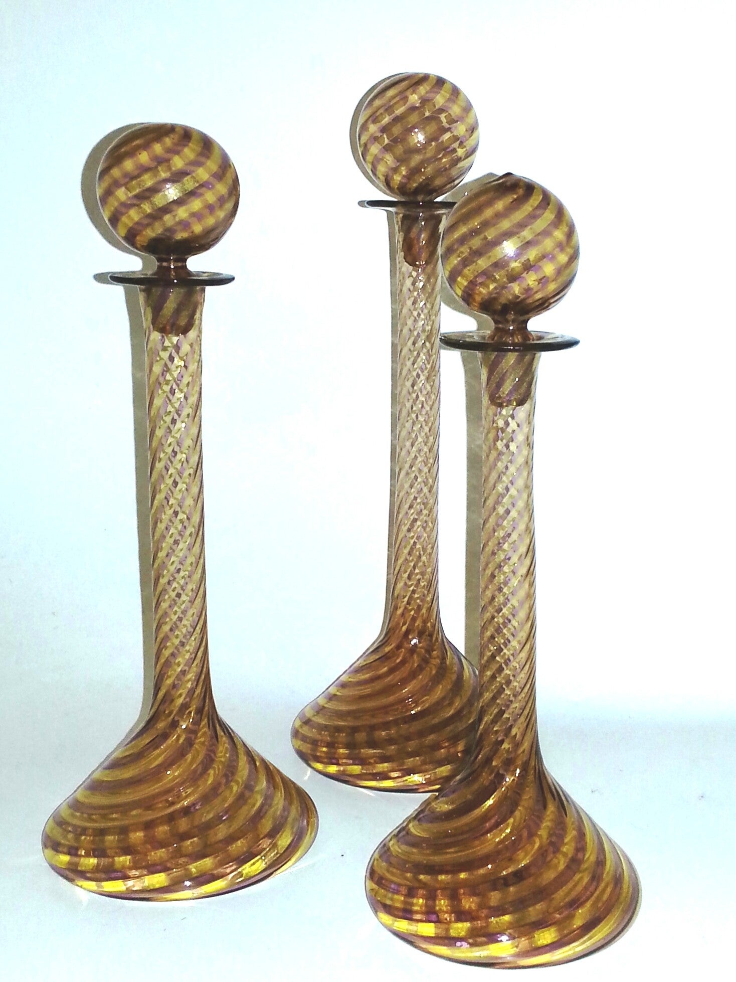 A Set Of Three Graduating Murano Decanters