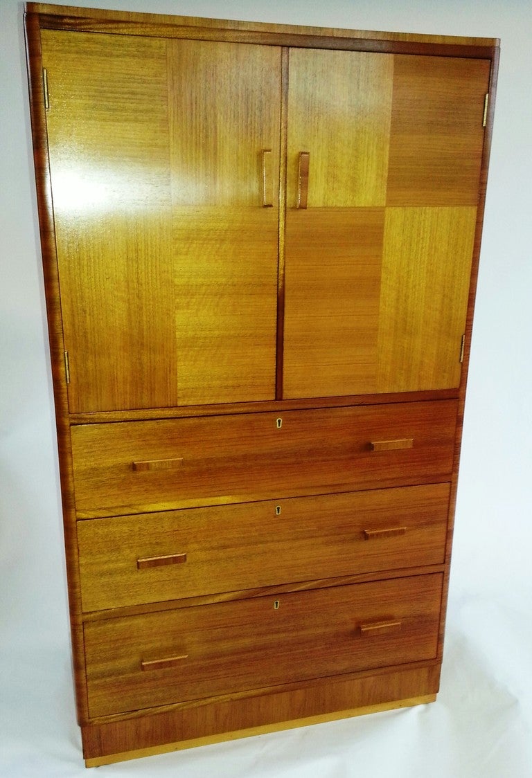 A Very Smart Art Deco Linen Press, Two door cupboard over three lockable Drawers, in a light banded walnut with nicely curved corners. 