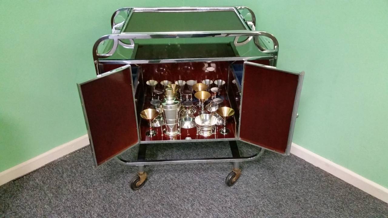 Art deco Cocktail Trolley. 
An Extremely Rare Art deco Bakelite and Chrome Cocktail Trolley with a compleate complement of cocktail glasses, shaker bowl and cocktail sticks. 
their are six Chanpagne bowls, six cocktail with gilt finish and six