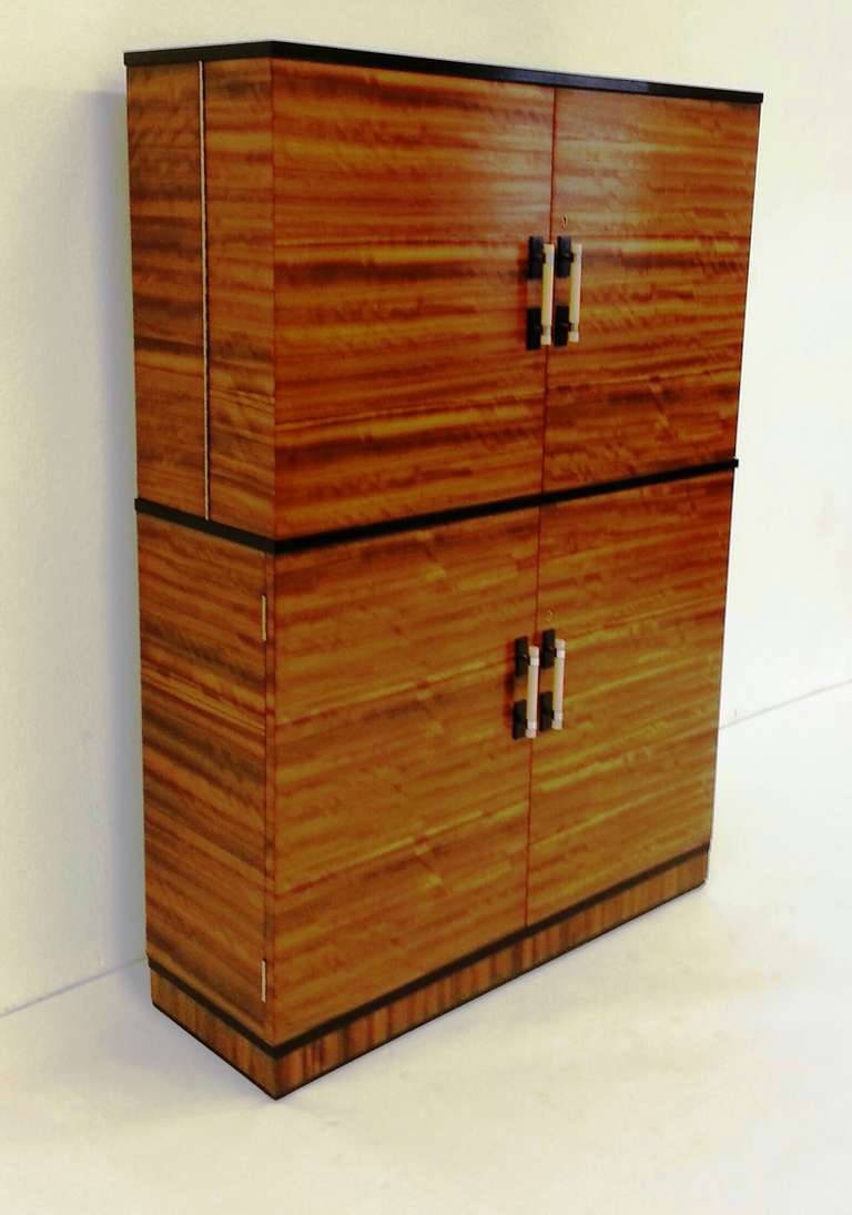 A Very Smart Art Deco Cocktail Cabinet, Beautiful Rosewood and ebony with Birds eye Maple interior, Ivory and bakelite handles.
108 cm to 216 cm wide with the doors fully opened. 35 Cm Deep 150 cm high.
French C 1930 