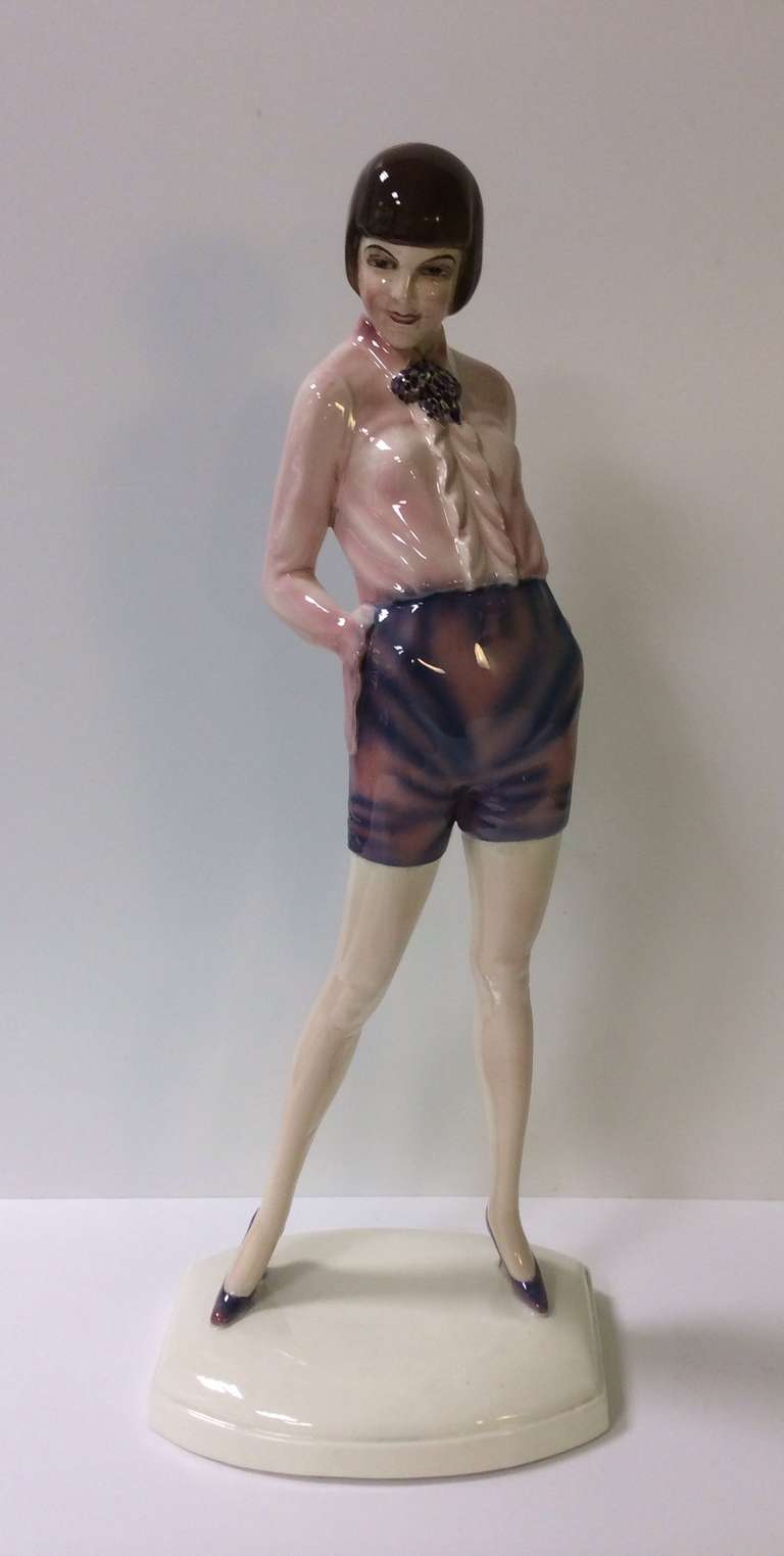 Beautiful Art Deco Figure By Goldscheider Of A Tall Slender Female In Purple Hot Pants And A Pink Blouse
A Model By Dakon 

Signed in the base Dakon 

GOLDSCHEIDERSCHE PORZELLAN-MANUFACTUR UND MAJOLICA-FABRIK (1885-1953)