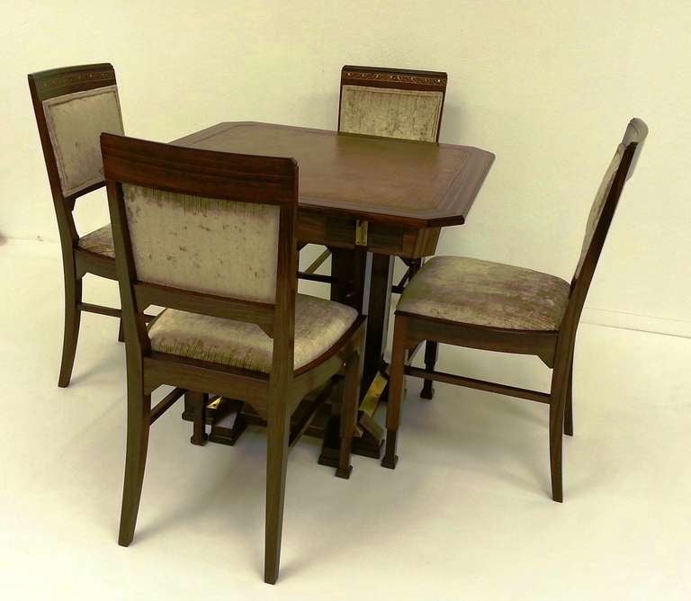 A fine Secessionists design games table and four chairs by Ludwig Schmitt.
A canted square section table with the frieze having an individual small drawer with a brass Handle to each side, the square section legs have inlaid mother of pearl with