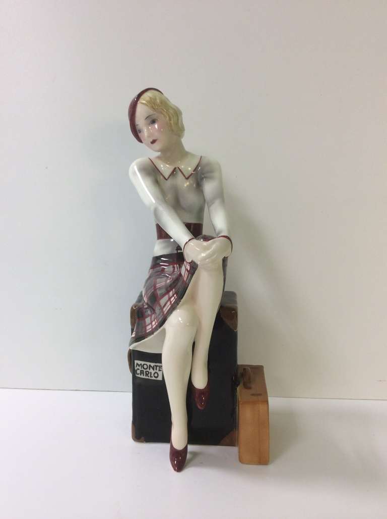 Another Fabulous Figure by Goldsheider, A Stylish young Lady sat upon her suitcase bound for Monte Carlo, a Model by Dakon model number 7472 77 10 

Literature: Ora Pinhas. Goldscheider Catalogue pg 130
