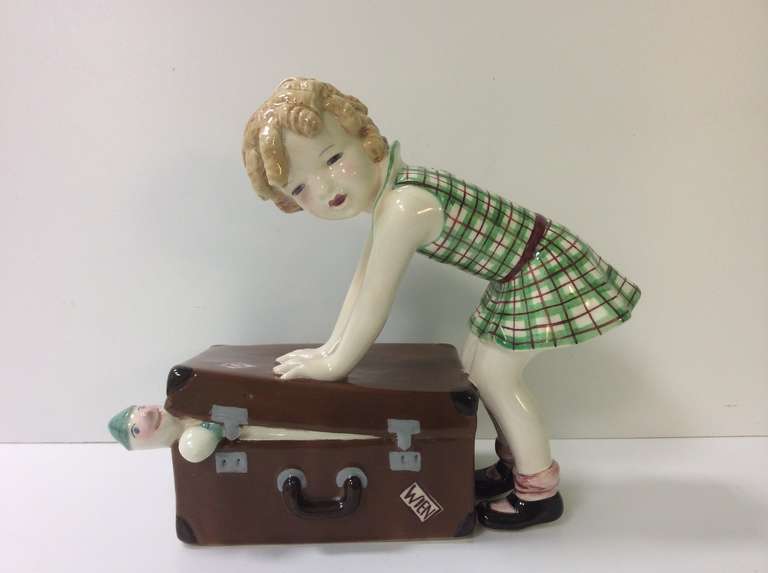 Absolutely Gorgeous Figure and A Girl with here suitcase, over packed with toys, the Girl with beautiful blond ringlets wearing a green check dress.
Produced by Goldscheider Wien, model number 7779 46 20 

Literature: Ora Pinhas Goldscheider